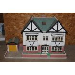 A modern 2 storey doll's house, with cream shutter windows, a cream and brick exterior,