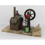 A large metal stationary engine, having copper cylinder boiler, and measuring 40 cm tall,