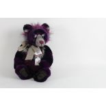 A Charlie bears teddy bear, "Errol", having a burgundy long pile plush covered body and a bow tie,