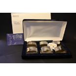 A cased set of 6 silver hallmarked napkin rings with booklet