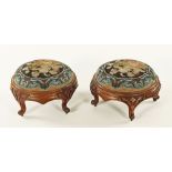 A pair of Victorian walnut circular beadwork upholstered footstools,