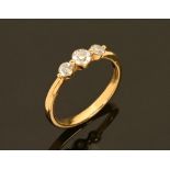 An 18 ct gold three stone diamond ring, total diamond weight +/- .50 carats. Size O.