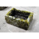 A rectangular sandstone trough, moss covered. Height 26 cm, width 66 cm, depth 47 cm.