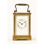 An Edwardian brass carriage clock, timepiece only. Height excluding carrying handle 12.3 cm.