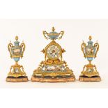 A 19th century French ormolu clock garniture, with Sevres style porcelain panels,