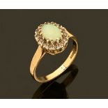 A 9 ct gold opal and diamond cluster ring. Size O/P.