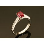 An 18 ct gold ruby and diamond ring, ruby +/- 2.15 carats, diamonds +/- .20 carats. Size N.