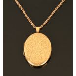 A 9 ct gold hand engraved locket, with 9 ct gold rope chain. 22 grams gross.