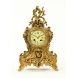 A continental brass mantle clock, in the rococo style with two train striking movement.