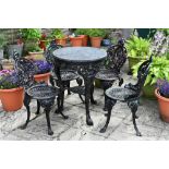 A Victorian style cast iron marble topped table, together with four chairs to match.