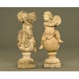 A near pair of composition garden cherub with cymbal figures, each raised on a plinth base.