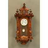 A late 19th century walnut Vienna regulator wall clock, with two train spring driven movement.