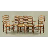 A set of six antique oak ladderback dining chairs, comprising two arm and six single chairs,
