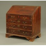 A George III oak bureau, with slope front to fitted interior with well.