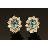 A pair of 18 ct white gold aquamarine and diamond cluster earrings, aquamarine +/- 1.