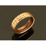 A 9 ct gold patterned wedding band, 3.1 grams. Size P.