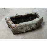 A rectangular form sandstone trough with angled corner. Height 21 cm, width 70 cm, depth 44 cm.