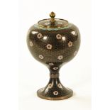 A cloisonne lidded urn, decorated with violet flower heads. Height 22 cm.