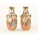 A small pair of Chinese Cantonese vases, decorated with panels of figures and foliage.