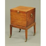 A George III mahogany cellarette with brass handles and fitted interior,