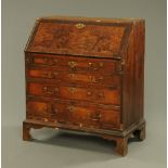 An antique walnut and mahogany crossbanded bureau,