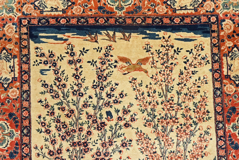 A pair of Eastern silky pile fringed rugs, decorated with various birds,