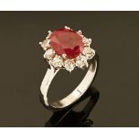 An 18 ct white gold ruby and diamond cluster ring, ruby +/- 3.03 carats, diamonds +/- .94 carats.