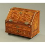 An antique walnut and inlaid table top bureau,