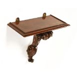 A Victorian mahogany bracket, with carved and scroll supports.