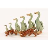 A collection of six Chinese graduated ducks, together with two prowling tigers. Tallest 24 cm.