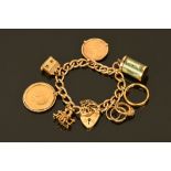 A 9 ct gold charm bracelet, with George V mounted sovereign,
