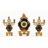 A French porcelain and metal clock garniture,