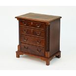 A Victorian style miniature chest of drawers,