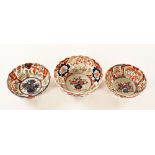 Three late 19th century Imari pattern earthenware enamel decorated bowls. Largest 21.5 cm diameter.