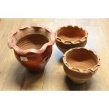 Three earthenware bowls, each with shaped rims,