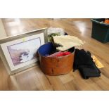 A collection of clothes in a metal hat box together with a watercolour of a coastal scene