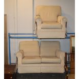 Cream patterned two seater settee and armchair