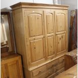 Large pine triple door wardrobe with five drawers to base, 208 cm tall, 158 cm wide,