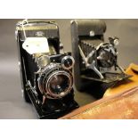 Two vintage folding cameras, one unmarked,