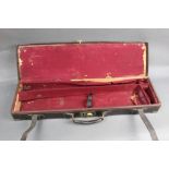 A leather and brass cornered shotgun motor case,