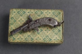 A Pinfire Derringer pistol, of small form. Length 4 cm, boxed.