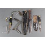 A collection of fixed blade and folding knives,