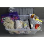 A plastic box containing fly tying materials, to include golden pheasant hackles, various furs,