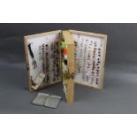 A double sided trout fly box containing trout flies, together with an alloy fly box,