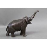 A late Meiji period bronze Asian Elephant figure, with outstretched trunk, height 10.