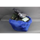 A bag containing six pigeon decoys, two crow decoys, one cammo net and one hide cammo cape.