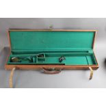 A canvas shotgun motor case, opening to a green baize lined interior for 28" barrels,