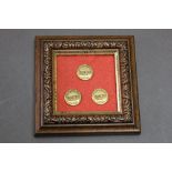 Three Cumberland Hunt buttons, marked to the rear Farmins London, 1.5 cm and housed in a frame.