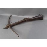 A late 18th/early 19th century crossbow, with walnut stock with brass stringing.