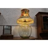 Large lamp with clear glass base and vintage tasselled shade,